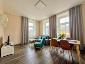 a living room with a table and chairs at Apartmány Mary in Litoměřice