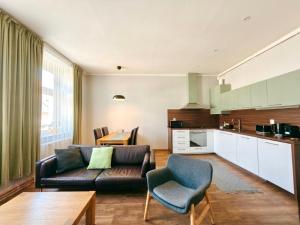 a living room with a couch and a table at Apartmány Mary in Litoměřice +44 photos