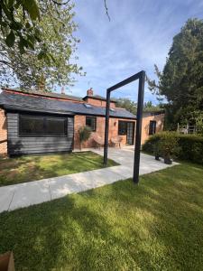 a house with a large mirror in the yard at Serenity Villa in Beccles