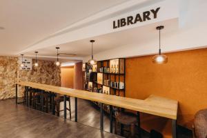 a library with a long table and chairs at Lago Resort Menorca - Casas del Lago Adults Only in Cala en Bosc +98 photos