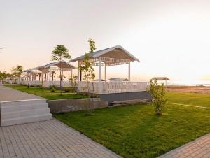 a row of pavilions with the ocean in the background at Astalanya City in Astara