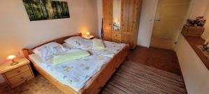 a small bedroom with a bed with a nightstand at Haus Alpaka in Bad König