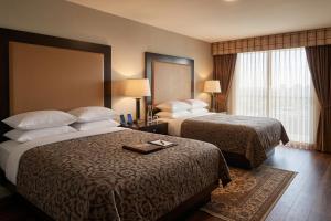 a hotel room with two beds and a window at La Casa Inn Albany Near Tifton GA I 75 in Albany