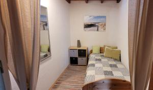 a small bedroom with a bed and a mirror at Haus Alpaka in Bad König