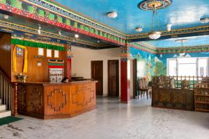a large room with a blue ceiling and a table at Hotel Sherwi Hyul in Kathmandu