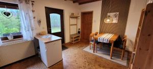a kitchen and dining room with a table and chairs at Haus Alpaka in Bad König