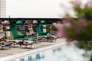 a row of chairs and a swimming pool at Clarion Hotel Arlanda Airport Terminal in Arlanda