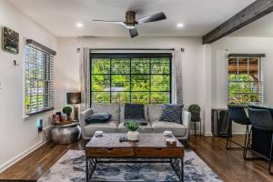 a living room with a couch and a table at LUX Private Oasis 4 Bed2 Bath Hot Tub 3 Patios Beltline Ansley Park in Atlanta
