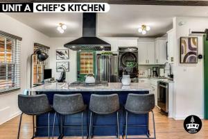 a kitchen with a large island with bar stools at LUX Private Oasis 4 Bed2 Bath Hot Tub 3 Patios Beltline Ansley Park in Atlanta +86 photos