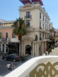 a building with a palm tree in front of it at Star Apartment 2- Spacious in the heart of Durres in Durrës