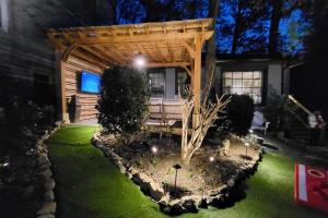 a pergola in the yard of a house at night at LUX Private Oasis 4 Bed2 Bath Hot Tub 3 Patios Beltline Ansley Park in Atlanta
