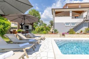 a villa with a swimming pool and patio furniture at Modern Villa Vesna with Private Pool in Jakići
