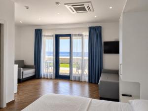 a bedroom with a bed and a view of the ocean at L'Ariana Resort, Glamping in Rinella +49 photos