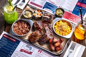 a tray of meat and other food on a table at Hotel PULSE8 in Prague
