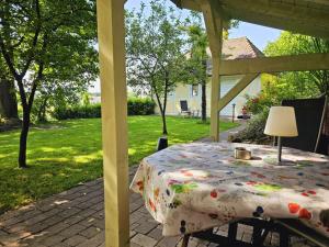 a table sitting under a gazebo in a yard at Gesindehaus Charis Ferienhaus nahe Europa Park mit eingezäuntem Garten ideal für Hunde Paare und Familien in Kippenheim +24 photos