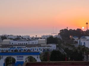 a view of a city with the sunset in the background at Appartement à m'diq in M'diq