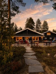 a log cabin with picnic tables in front of it at Aldeia Bianca Lake Resort & Italian Restaurant in Kerimäki +70 photos