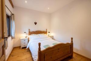 a bedroom with a wooden bed and a wooden floor at Top Floor Chalet Apartment in Saint-Jean-d'Aulps, Balcony in Saint-Jean-d'Aulps