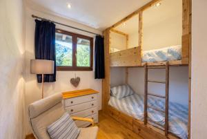 a tiny house with a desk and bunk beds at Top Floor Chalet Apartment in Saint-Jean-d'Aulps, Balcony in Saint-Jean-d'Aulps