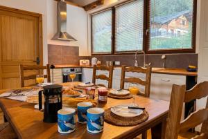 a wooden table in a kitchen with glasses of wine at Top Floor Chalet Apartment in Saint-Jean-d'Aulps, Balcony in Saint-Jean-d'Aulps