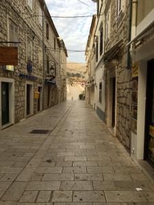 an empty street in an old town with buildings at House Mima in Pag