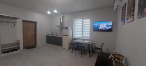 a kitchen with a small table and a kitchen with a counter at Уютная квартира в Одессе in Odesa