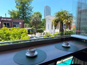 two cups of coffee on a table on a balcony at Hotel Park in Batumi