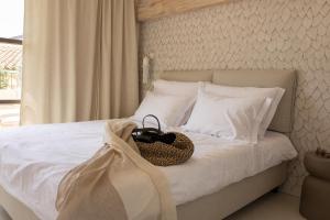 a bedroom with a bed with a basket on it at Stone House Orsera II in Vrsar
