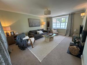 a living room with a couch and a table at The Little Vicarage in Highbridge