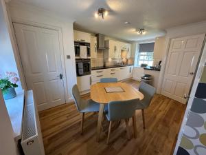 a kitchen and dining room with a table and chairs at The Little Vicarage in Highbridge