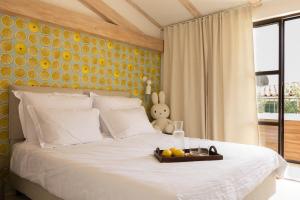 a bedroom with a bed with a tray of fruit on it at Stone House Orsera II in Vrsar +15 photos