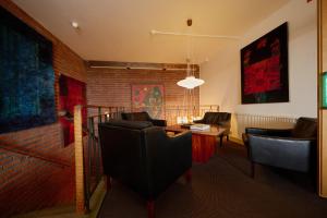 a living room with couches and a brick wall at Hotell Hanöbris på Kivik in Kivik