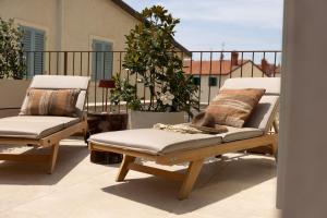a pair of chairs sitting on a balcony at Stone House Orsera II in Vrsar