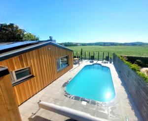 a swimming pool on a patio next to a house at Zoet & Zout in Zoutelande