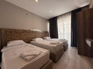 a hotel room with two beds and a window at Livane Beach Hotel in Alanya