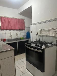 a kitchen with a black and white stove top oven at Casa Harmonia in Trairi +13 photos