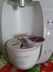 a tassimo machine with a lid on a toilet at Maisonnette de village in Mosnes