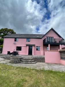 a pink house with a black roof at The Farmhouse in Teignmouth