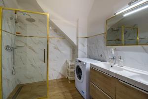 a bathroom with a washing machine and a sink at Dolistówka Apartamenty z jacuzzi i sauną in Goniadz +72 photos