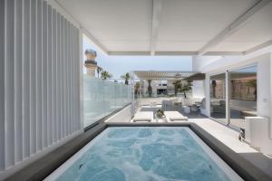 a swimming pool on the balcony of a building with a lighthouse at Ierapetra’s Mosque House in Ierapetra