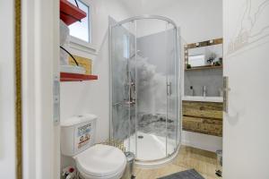 a bathroom with a shower with a toilet and a sink at Comme à la maison in Ducey +12 photos
