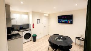 a kitchen with a table and chairs in a room at Cosy Flat on the Top Floor in Ramsbottom in Ramsbottom