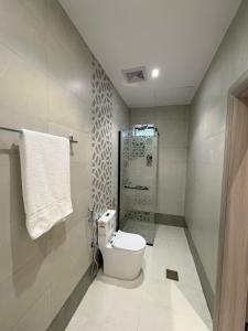 a bathroom with a toilet and a shower at Qubaa Soul Studio 2-3 in Medina +21 photos