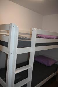 two white bunk beds in a room at Leona in Senj