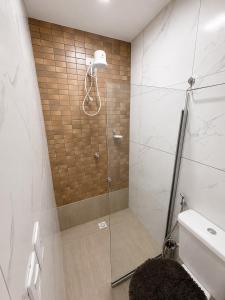 a shower with a glass door in a bathroom at Manaira Suite 02 in João Pessoa