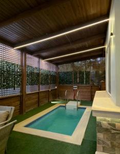 a swimming pool in a house with a patio at كمبوند العالمية in Madinat Al Ashir min Ramadan