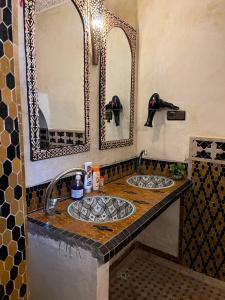 a bathroom with two sinks and a mirror at Riad Ouliya in Fez +99 photos