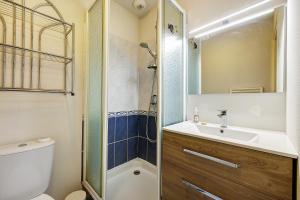 a bathroom with a toilet and a sink and a shower at Maison La Parée Plage in Bretignolles-sur-Mer +25 photos