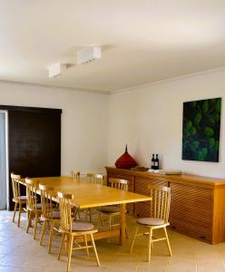 a dining room with a wooden table and chairs at Herdade do Burrazeiro Turismo Rural no Alentejo in Borba