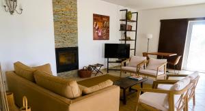 a living room with a couch and a fireplace at Herdade do Burrazeiro Turismo Rural no Alentejo in Borba